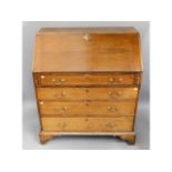 An 18thC. Georgian oak bureau with ogee feet & bra