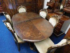 A regency style dining table with six upholstered