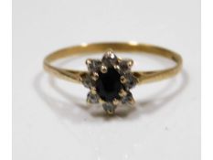 A 9ct gold ring set with sapphire & white stones,