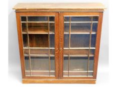 A 19thC. bookcase with later plinth lacking one gl