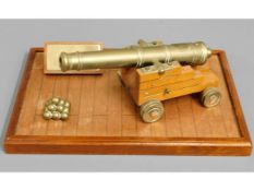 A mounted brass cannon "HMS Cambridge", plinth 14i