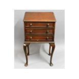 A three drawer mahogany cabinet on cabriole legs,
