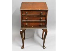 A three drawer mahogany cabinet on cabriole legs,