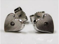 A pair of 9ct white gold heart shaped earrings set