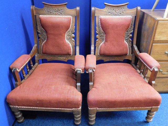 A pair of Edwardian upholstered arm chairs