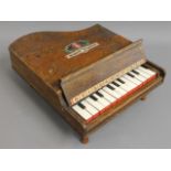 A child's miniature piano, one key not playing, 13