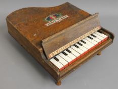 A child's miniature piano, one key not playing, 13