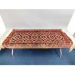 A decorative wool runner carpet, fault to edge, 65