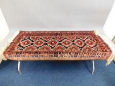 A decorative wool runner carpet, fault to edge, 65