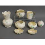 A collection of eight pieces of Belleek porcelain,