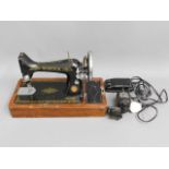A cased Singer electric sewing machine