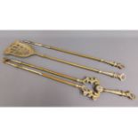 A large brass companion set, 32in long