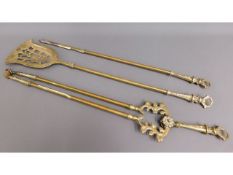 A large brass companion set, 32in long