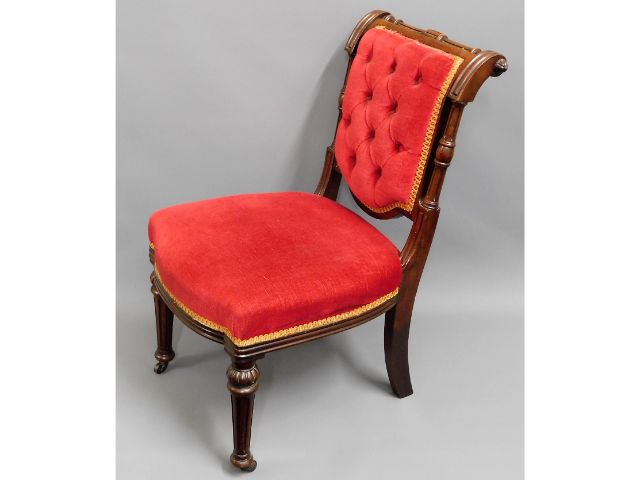 An antique, upholstered nursing chair