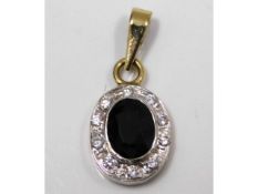 A 9ct gold pendant set with diamond & sapphire, 11