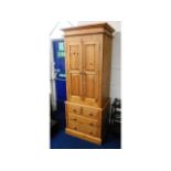 A modern solid pine, three piece wardrobe with dra