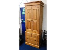 A modern solid pine, three piece wardrobe with dra