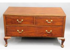 A low level mahogany chest of drawers with brass f