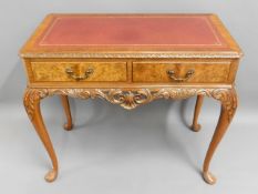 A decorative walnut veneered two drawer writing ta