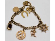 A 9ct gold charm bracelet including masonic pendan