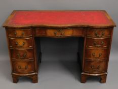 A serpentine fronted desk fitted with seven drawer