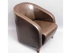 A upholstered leather tub chair