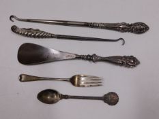A silver fork & white metal spoon with three silve
