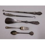 A silver fork & white metal spoon with three silve