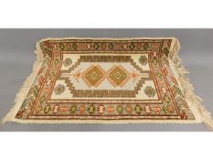 A decorative wool carpet, 46.5in long x 30in wide