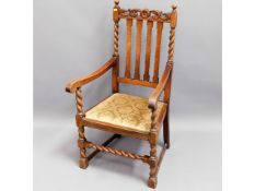 An oak throne style carver chair with barley twist