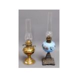 An antique opalescent glass oil lamp twinned with