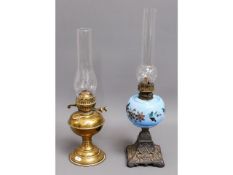 An antique opalescent glass oil lamp twinned with