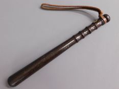 A hard wood police truncheon stamped NSC, 15in lon