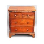 A small chest of three drawers with writing tray,