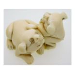 An early 20thC. Japanese netsuke of two puppies