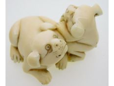 An early 20thC. Japanese netsuke of two puppies