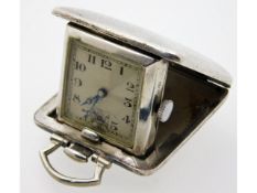 A small silver cased travel clock, winds & runs, 1