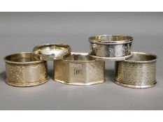 An 1877 Exeter silver napkin ring, one London, thr