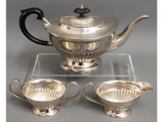 A three piece silver plated tea set with gadrooned