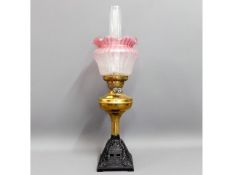 A Victorian brass oil lamp with cast iron base & c