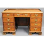 A 19thC. mahogany knee hole desk with nine drawers