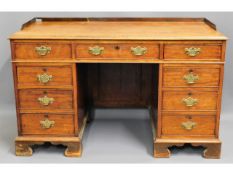 A 19thC. mahogany knee hole desk with nine drawers