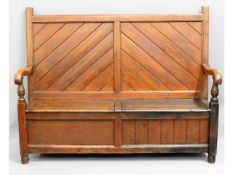 A late 19thC. pitch pine monks bench, one side pan