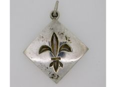 A silver fleur-de-lys pendant made by the late Cor