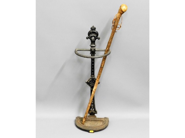 A Victorian cast iron stick stand & walking cane,