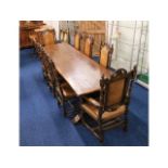 A substantial oak trestle table with six leather u