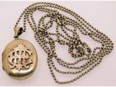 An antique white metal locket, tests as silver set