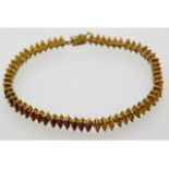 A 9ct gold bracelet set with marquise cut red, yel