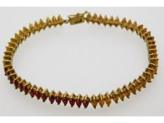 A 9ct gold bracelet set with marquise cut red, yel