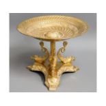 An ornate Regency style brass tazza with dolphin d